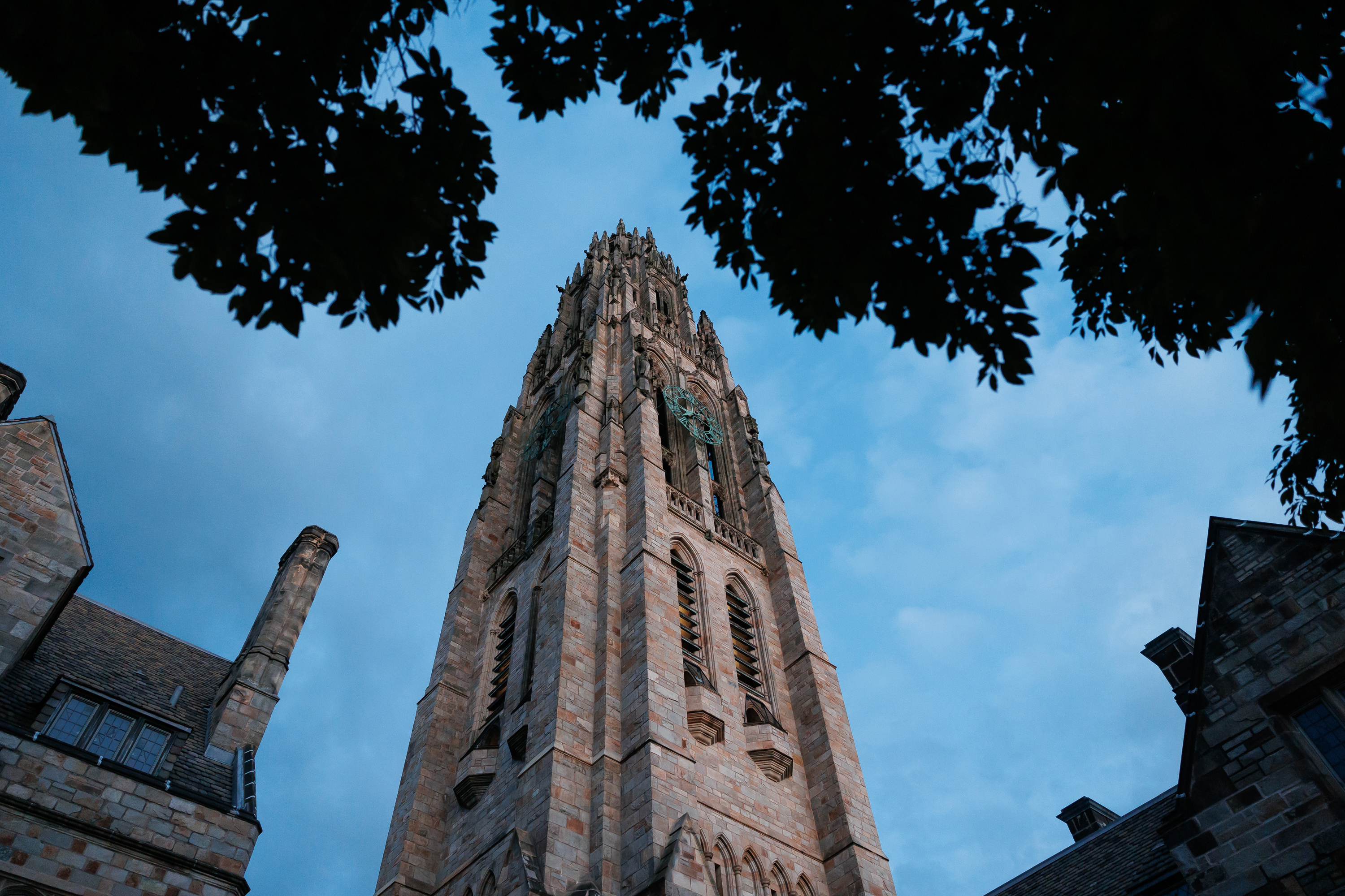 Harkness Tower rises dramatically into the darkening sky at dusk