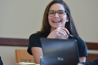Person sitting at table smiling